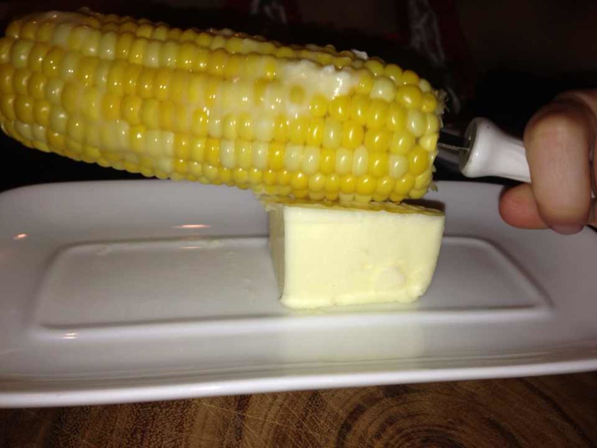 Rub butter on the corn.