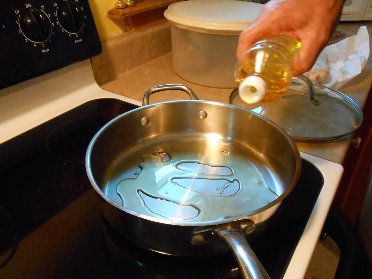 Heat oil in a large stainless steel skillet on medium-high heat.