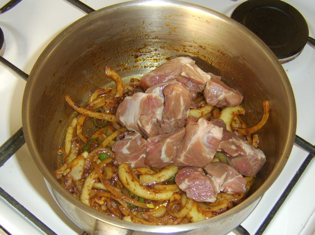 Lamb is added to the softened onion and spices