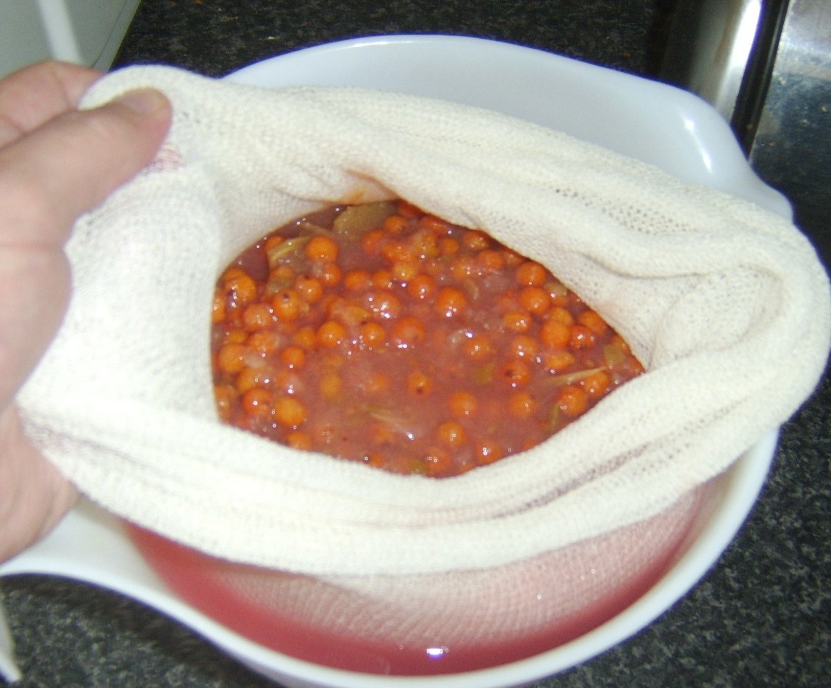 Stewed rowan berry and apple combination is poured in to a muslin cloth bag