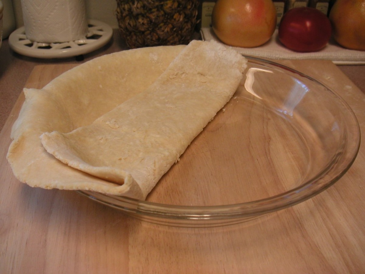 Continue unfolding, positioning the dough to reach the edges of the pan.