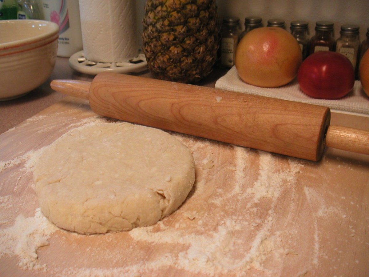 Roll out the dough on a floured surface dusting the rolling pin with flour, too.