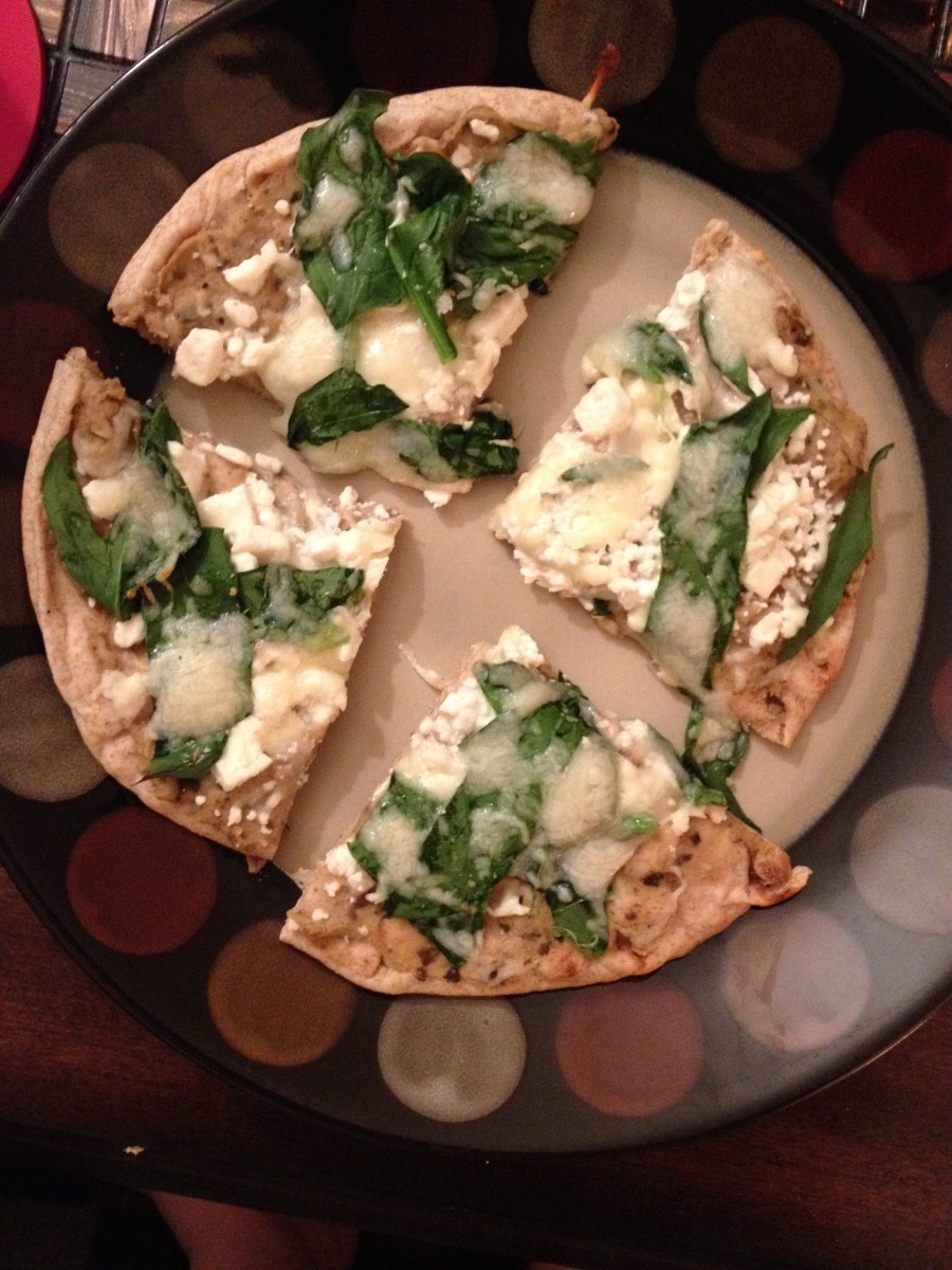 This is another version of the pizza. It has black olive hummus, spinach, the leftover feta, and some Italian cheeses on top.