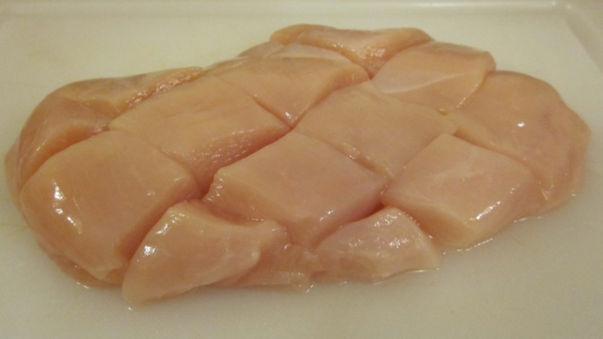 Clean, trim, and cut the chicken breast on the diagonal for tenderness.