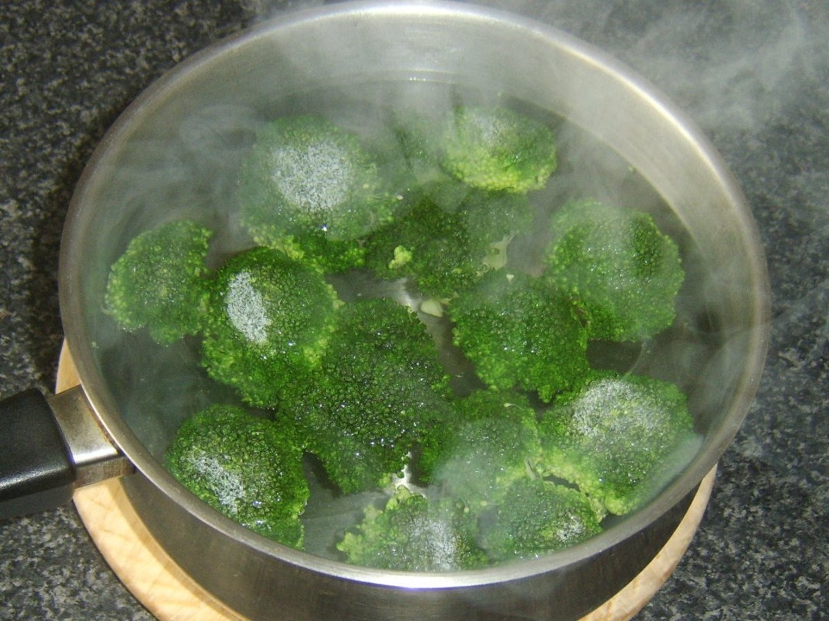 Broccoli florets are poached in salted water