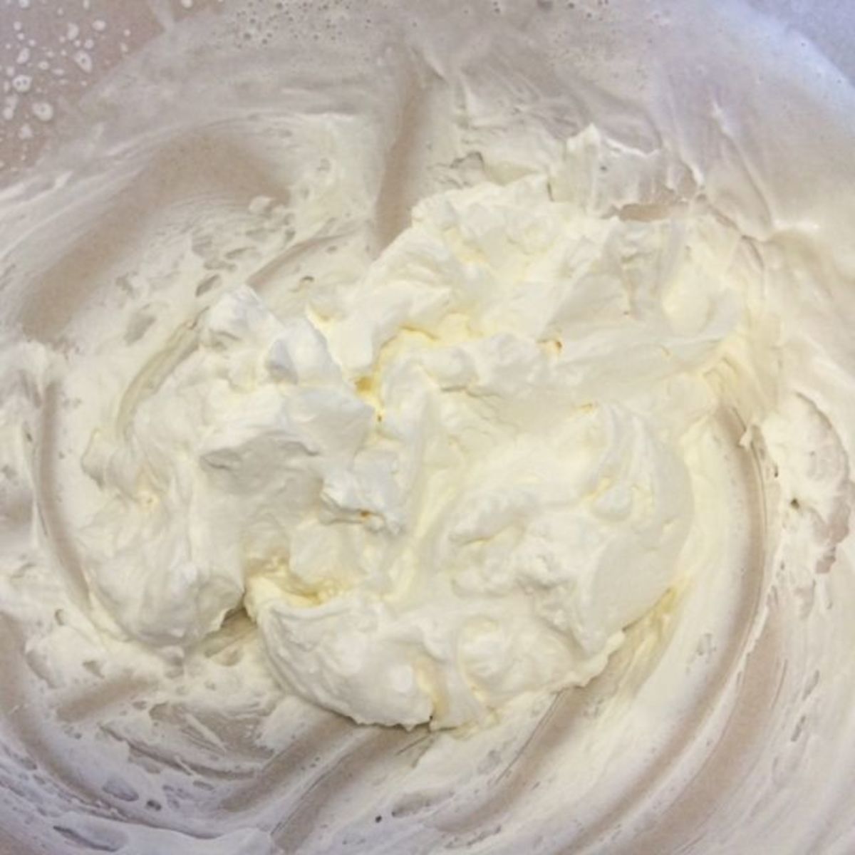 Whip the cream until stiff peaks form.