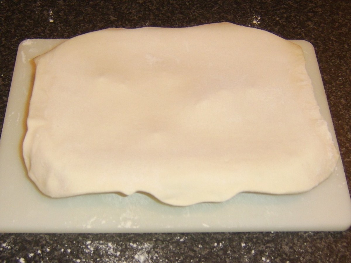 Rolled pastry is laid on top of the steak, beetroot and Stilton pie filling