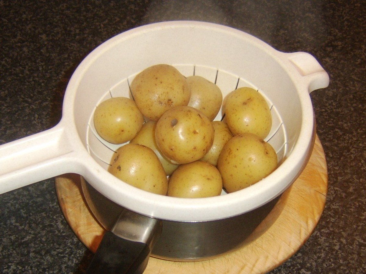 Baby potatoes are boiled in their skins and carefully drained