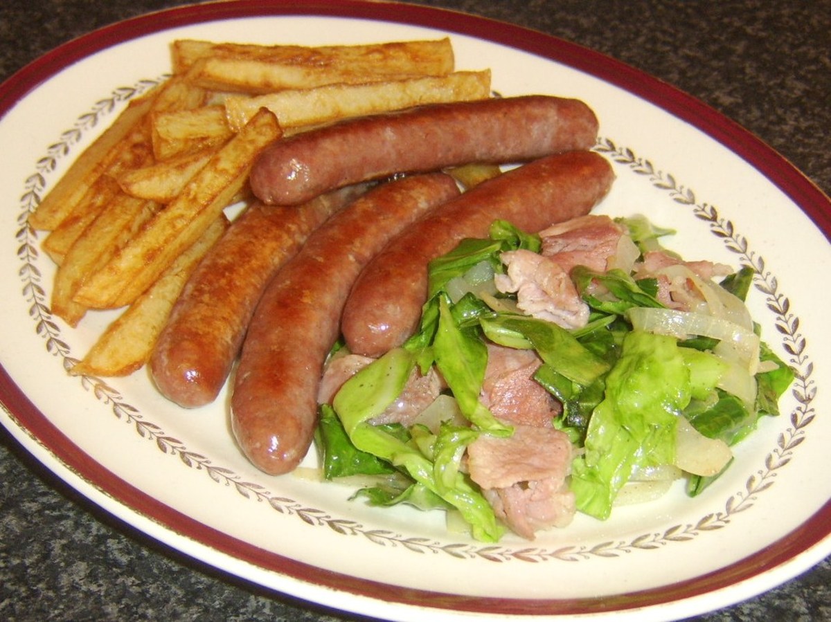 Sweetheart cabbage is sauteed with bacon and served with sausages and chips.
