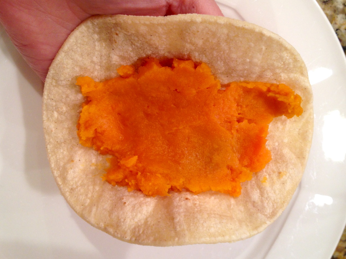 Spoon about 1/8 of mashed sweet potatoes down the center of a warmed tortilla.