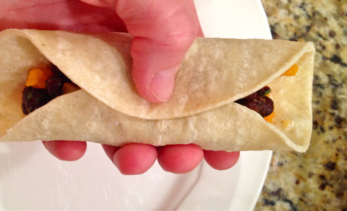 Wrap and roll the tortilla as shown.