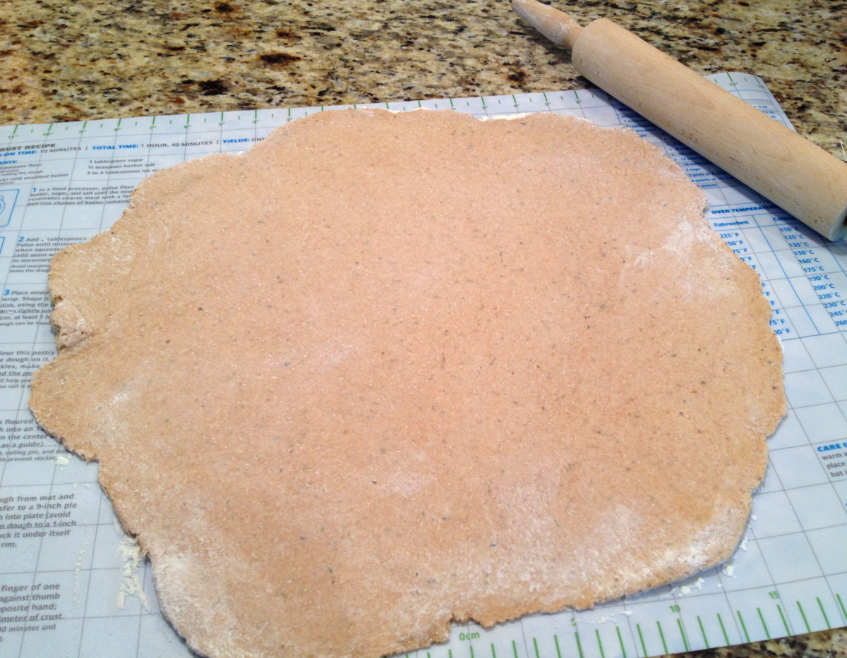 Roll out pizza dough on a floured surface to about a 14-inch circle. Carefully transfer dough to heated pizza stone (or other pizza pan).