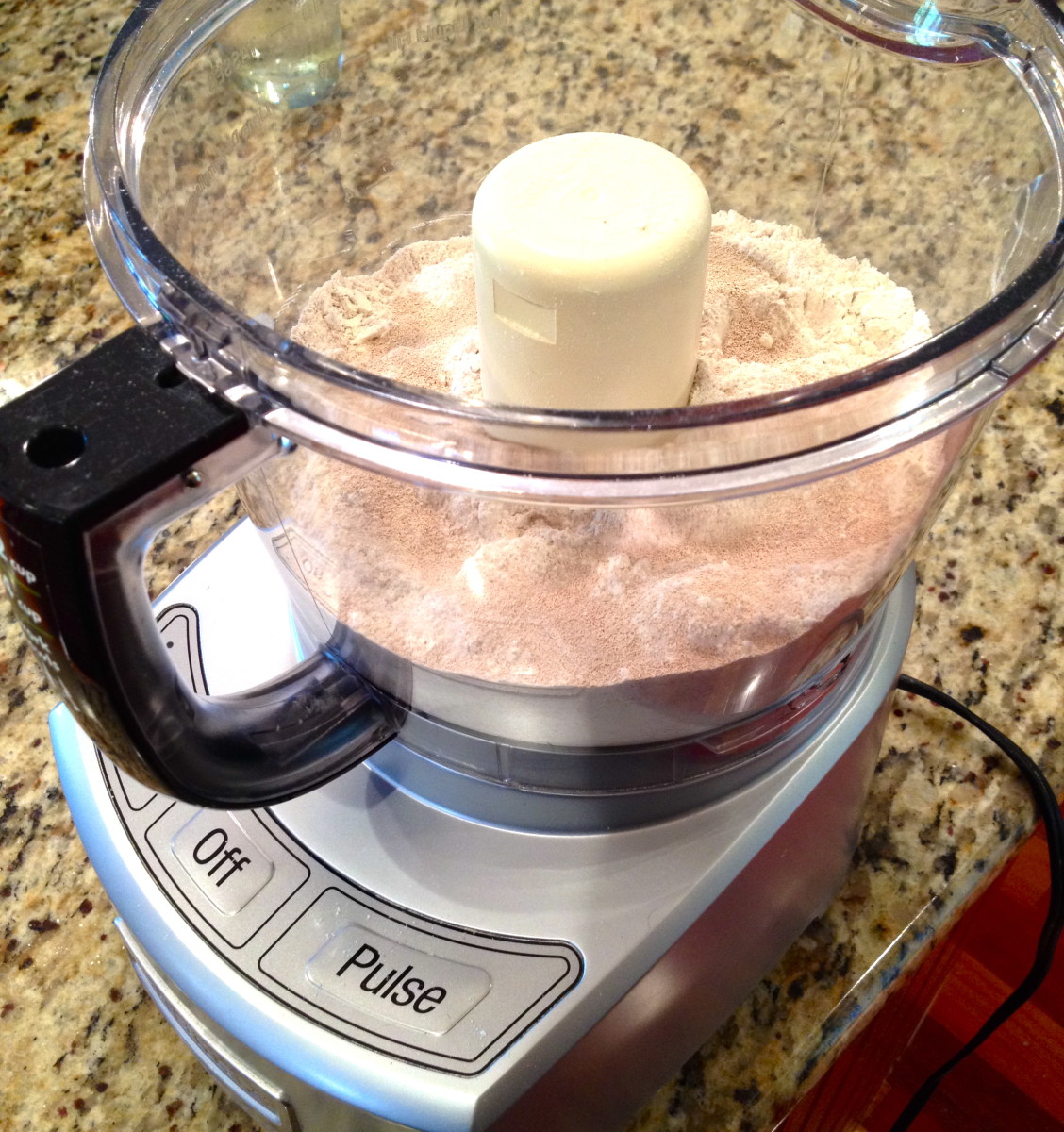 Combine flours, yeast, and sugar in a food processor. Pulse to mix ingredients. 