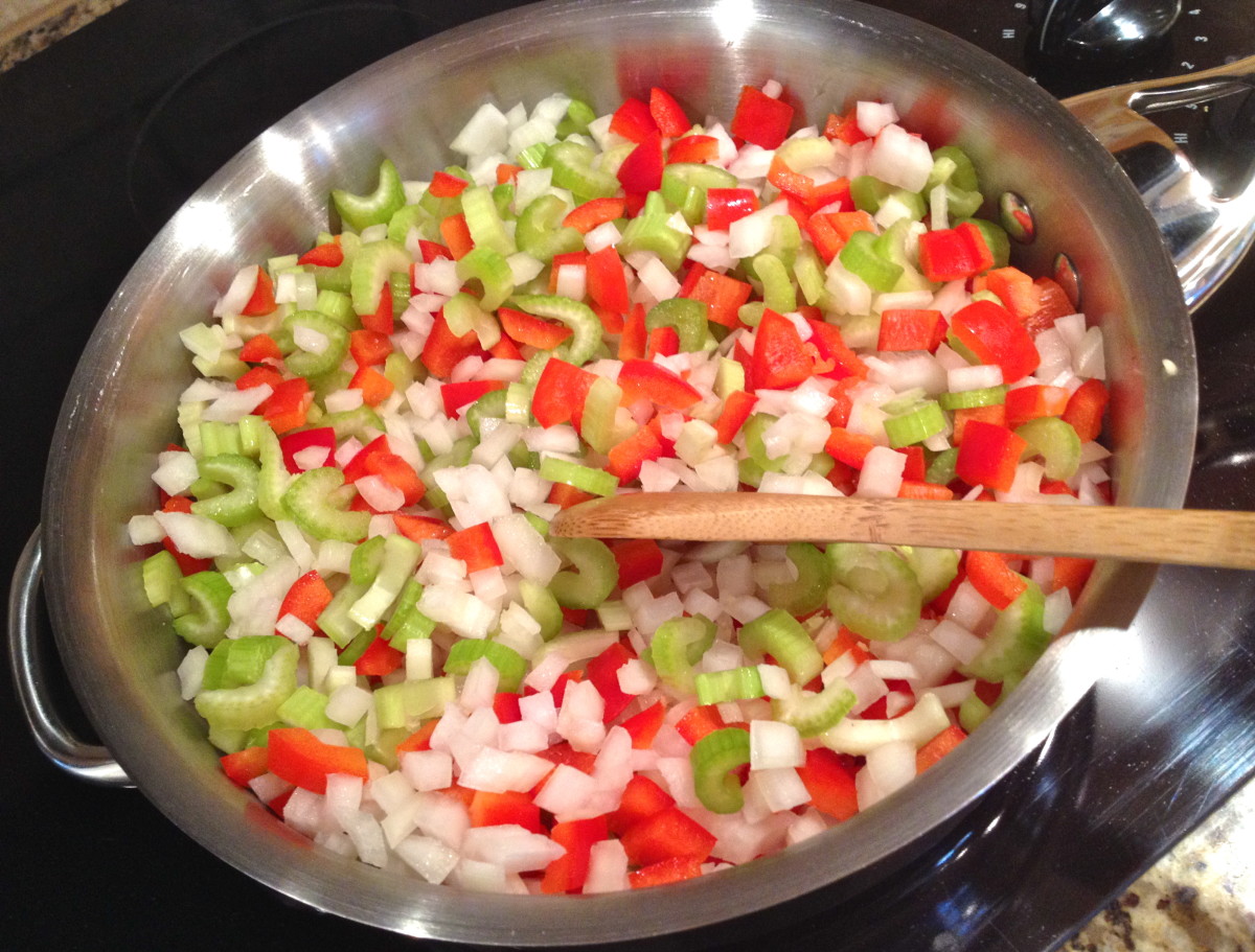 Cook chopped vegetables and minced garlic in oil over medium-low heat until tender, about 20 minutes.