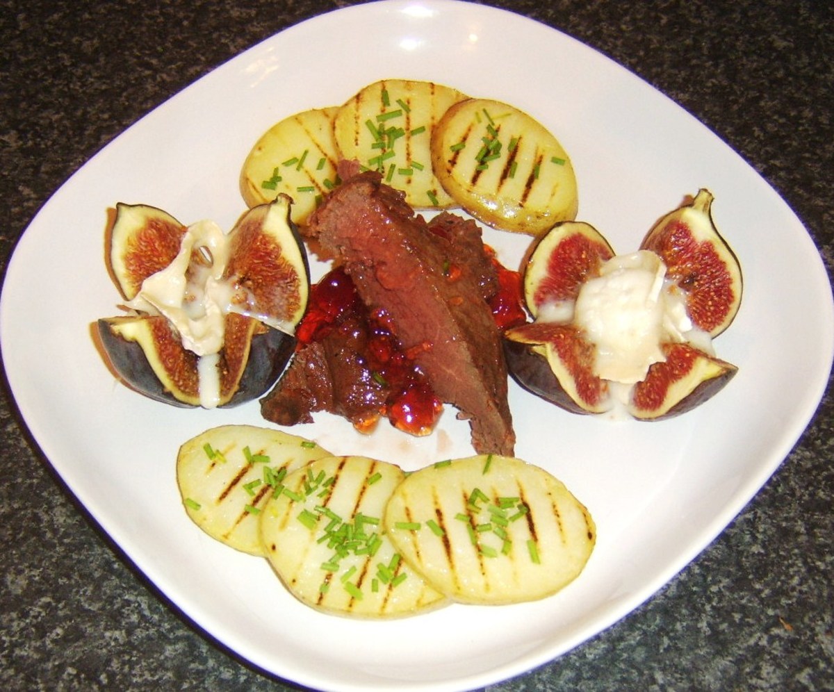 Griddled ostrich steak served with figs with goats cheese and griddled potato slices