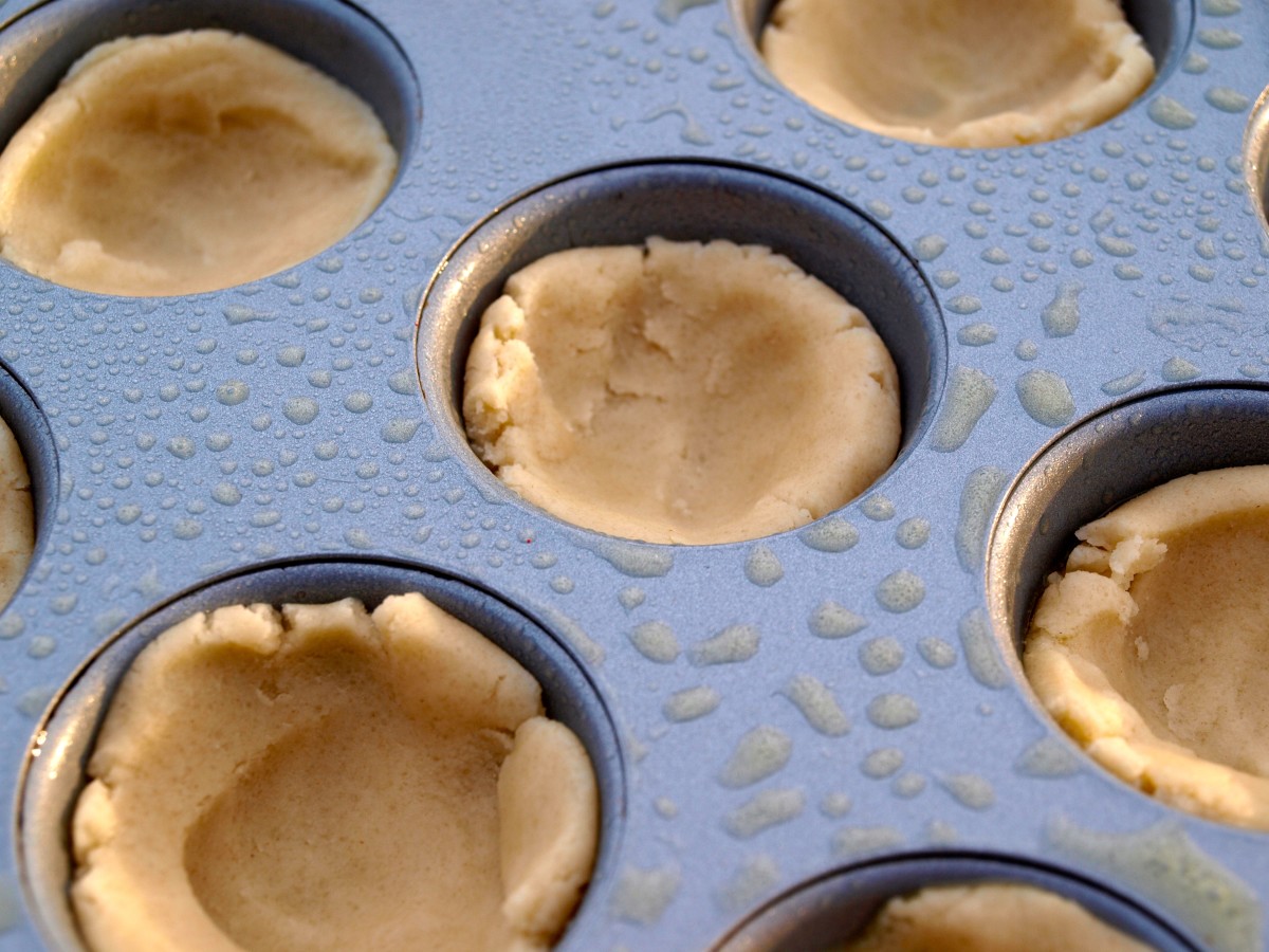Shape the dough into cookie cups, making sure to get the dough up the sides of the tray.