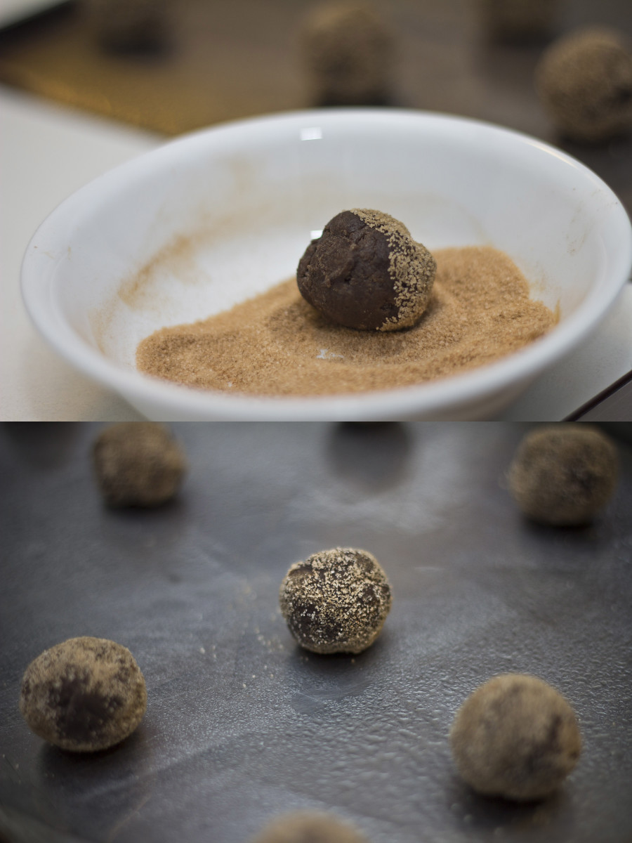 Dark chocolate snickerdoodle cookie balls, rolled in cinnamon and sugar, and ready to be placed in the oven.