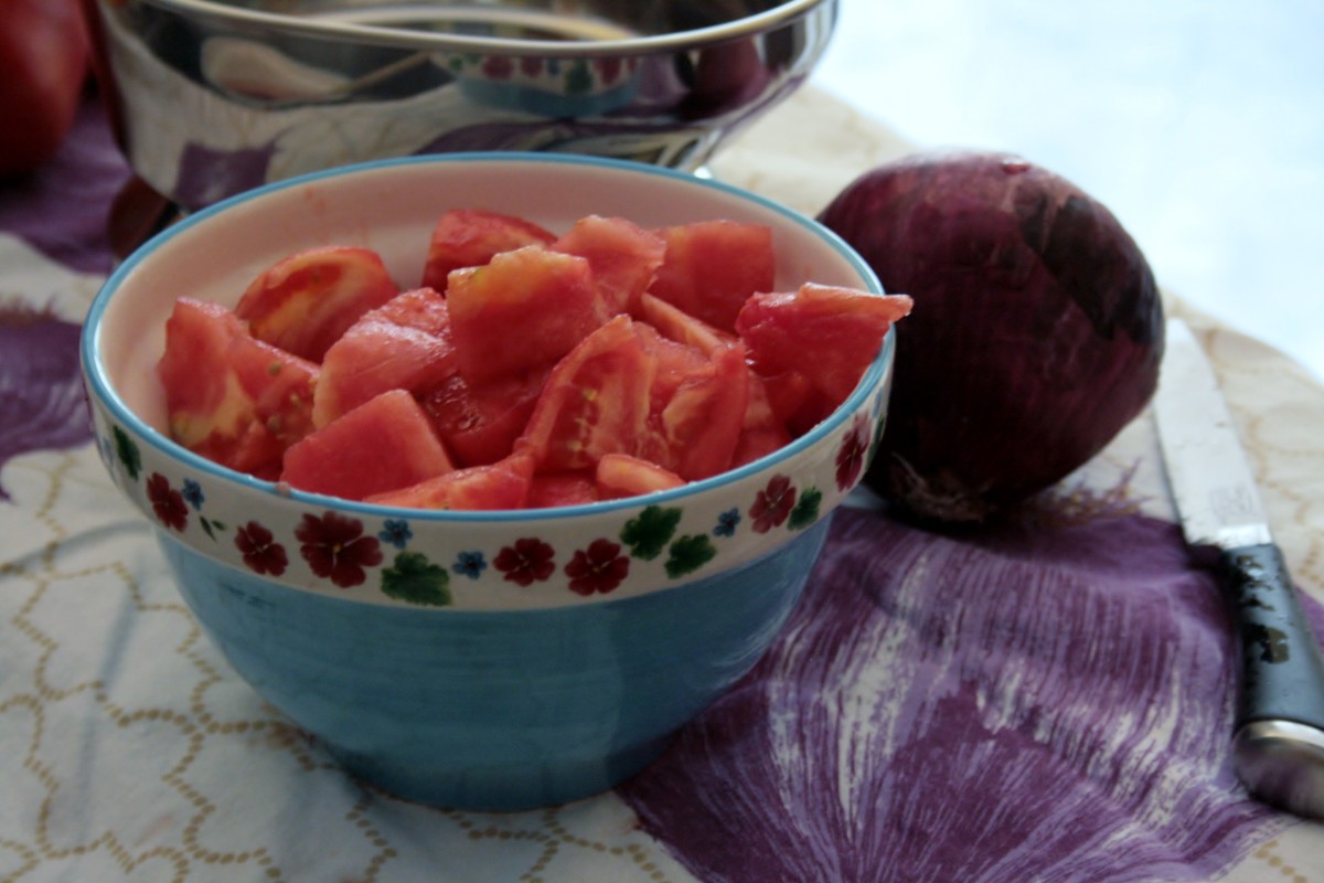 Once the tomato wedges are a manageable size, cut them horizontally into bite-sized chunks ideal for sauces and stews.