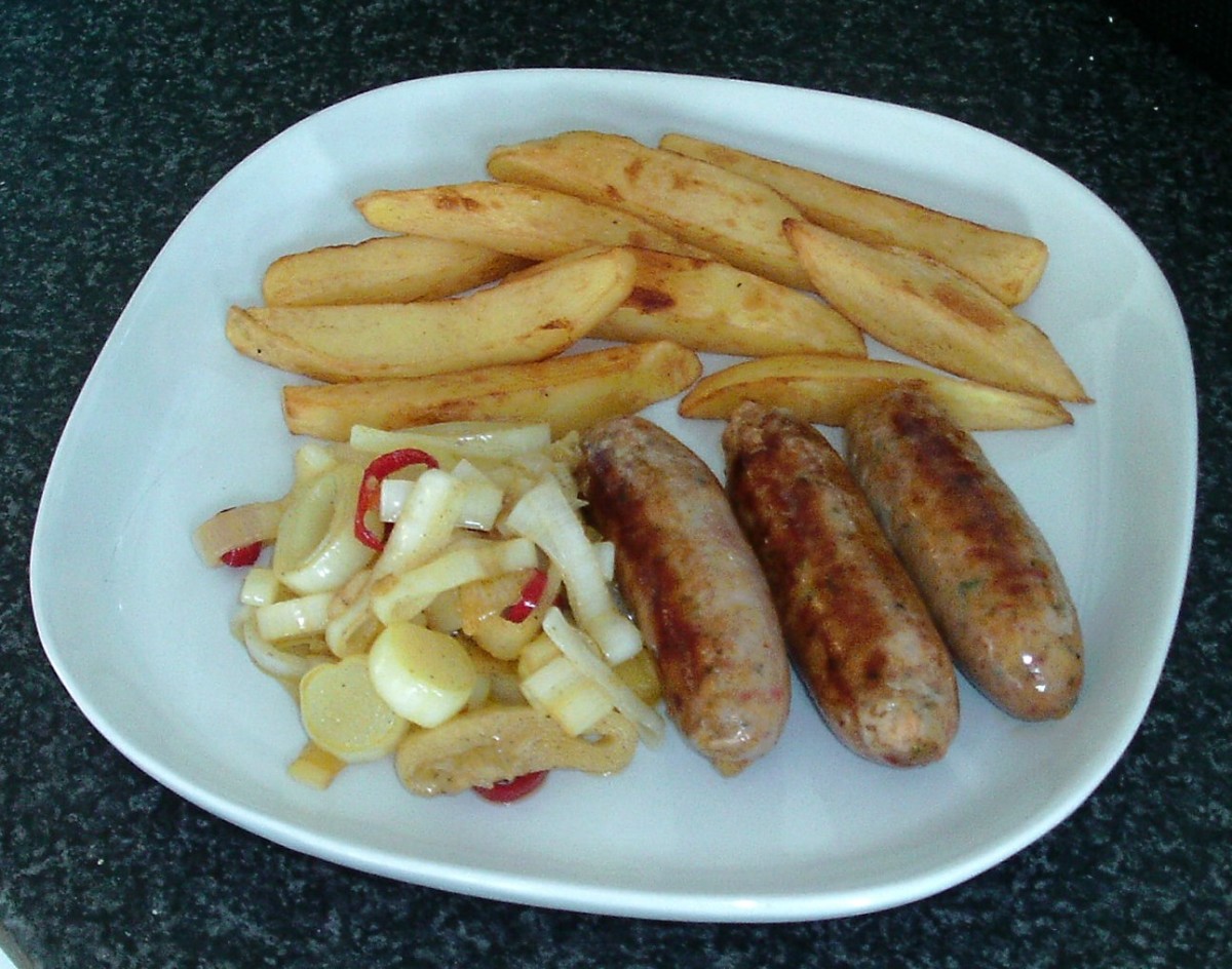 Pan fried leeks with chilli and garlic are served with chilli sausages and homemade chips