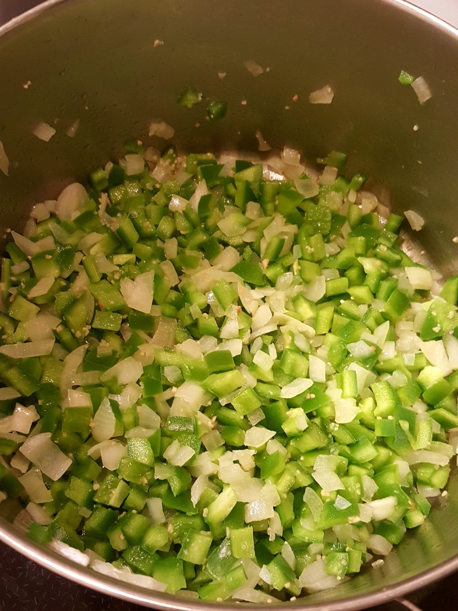 Saute onions, peppers, and garlic in oil.