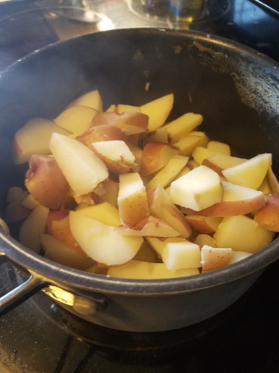 Chop up the potatoes and boil them in a pot for about twenty minutes, or until soft.