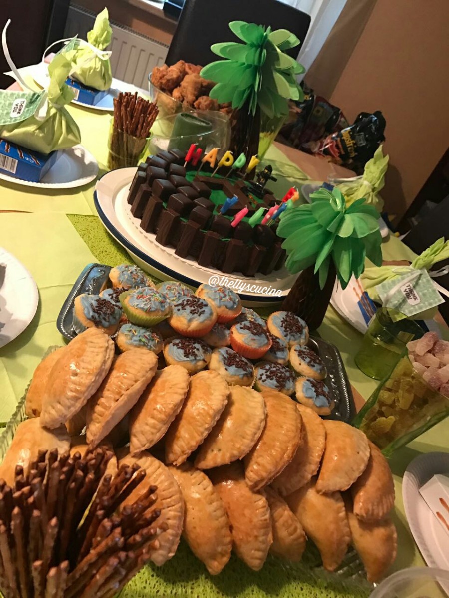 The birthday buffet with "Minecraft" cake, empanadas, cupcakes, chocolates, and other goodies for the kids' afternoon party