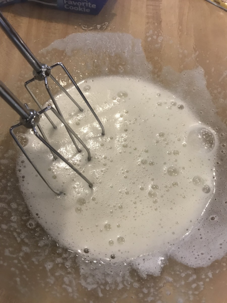 Remove the bowl from the heat once the sugar has dissolved and the egg whites are white and frothy. Beat with a mixer until stiff, glossy peaks form.