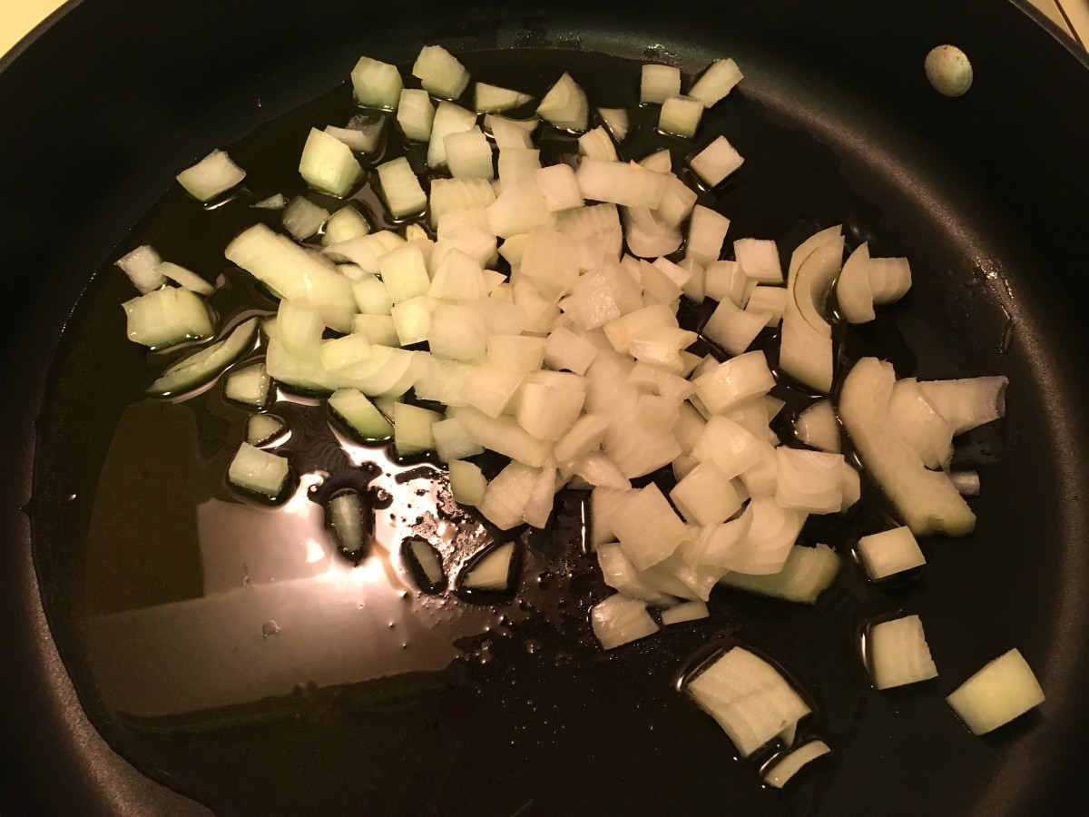 Add onions and garlic to heated olive oil.