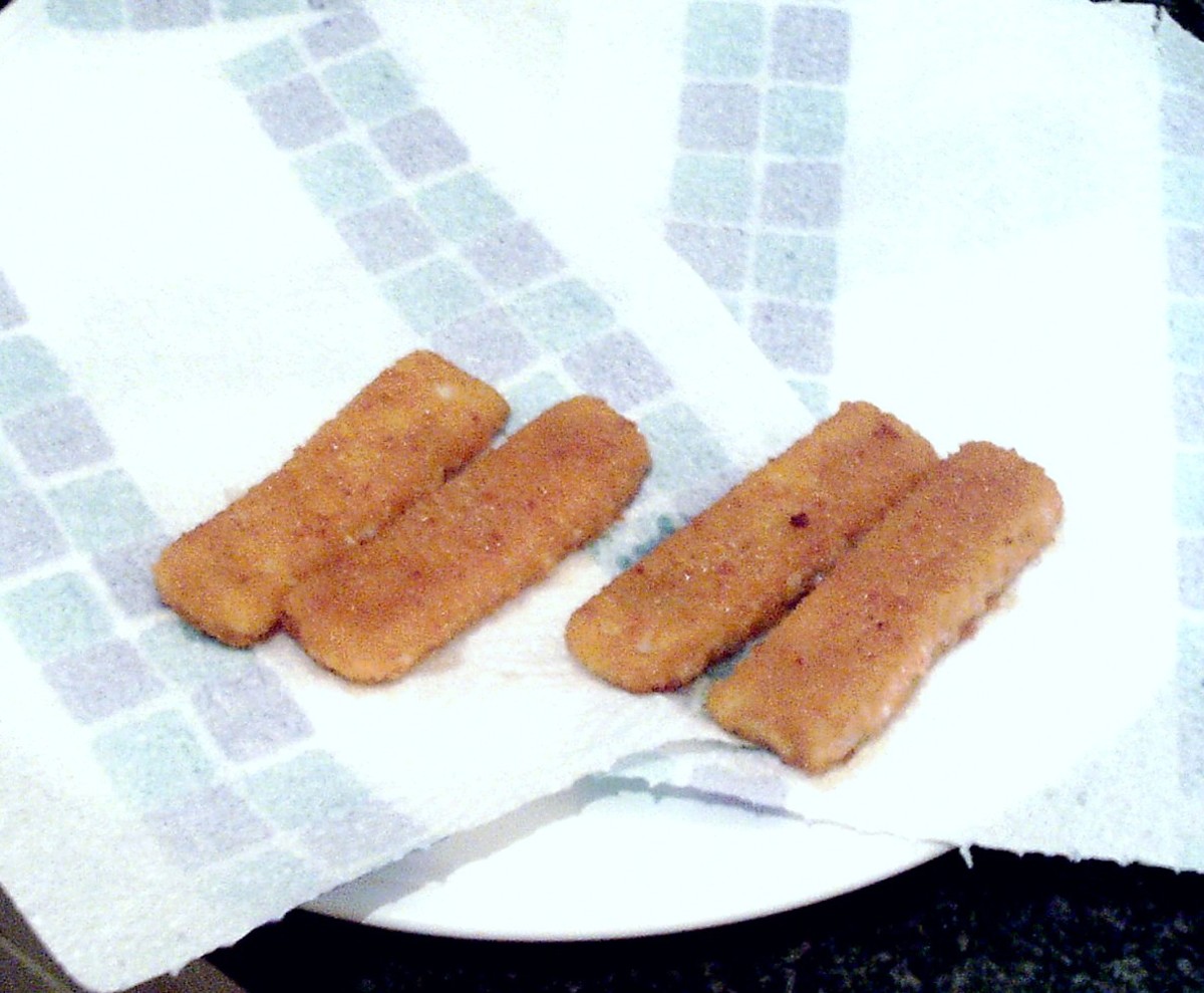 Fish fingers are drained on kitchen paper