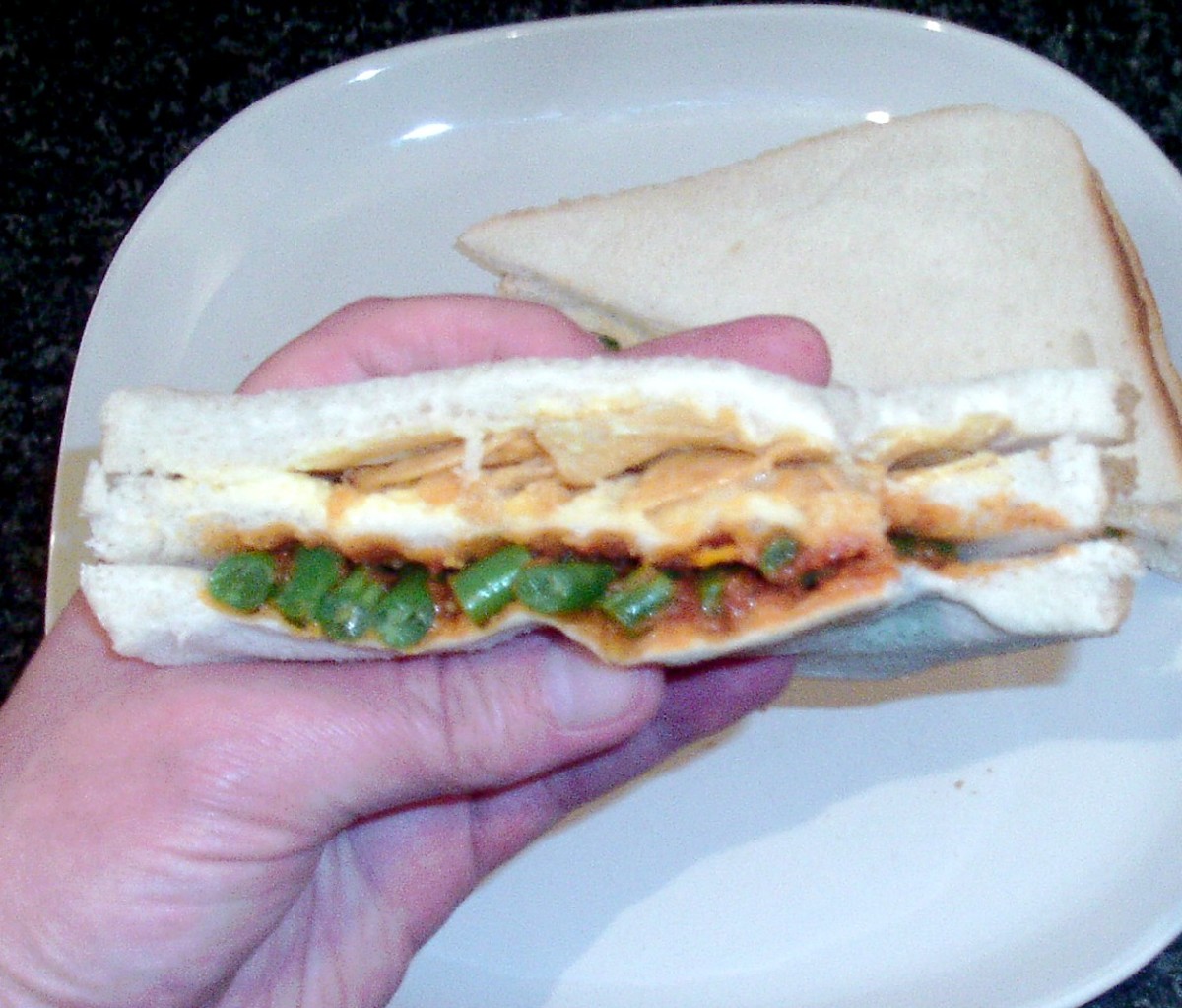 Spicy beans in tomato sauce in the bottom layer and cheese and onion crisps in the top layer sandwich