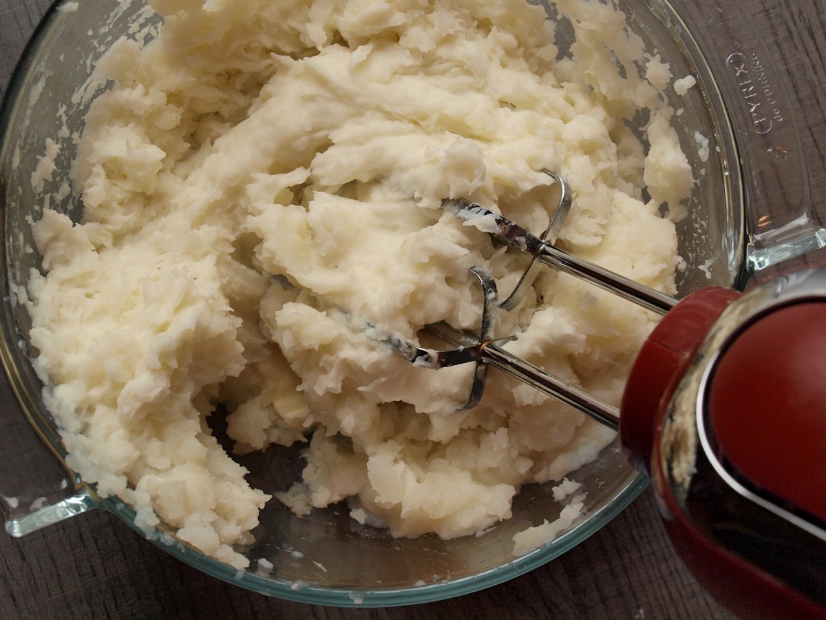 Mashing potatoes with a mixer.