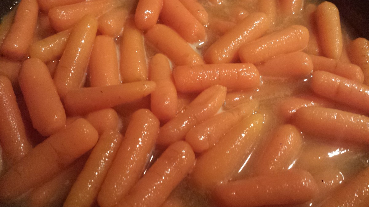 Stirring the carrots into the honey mixture.