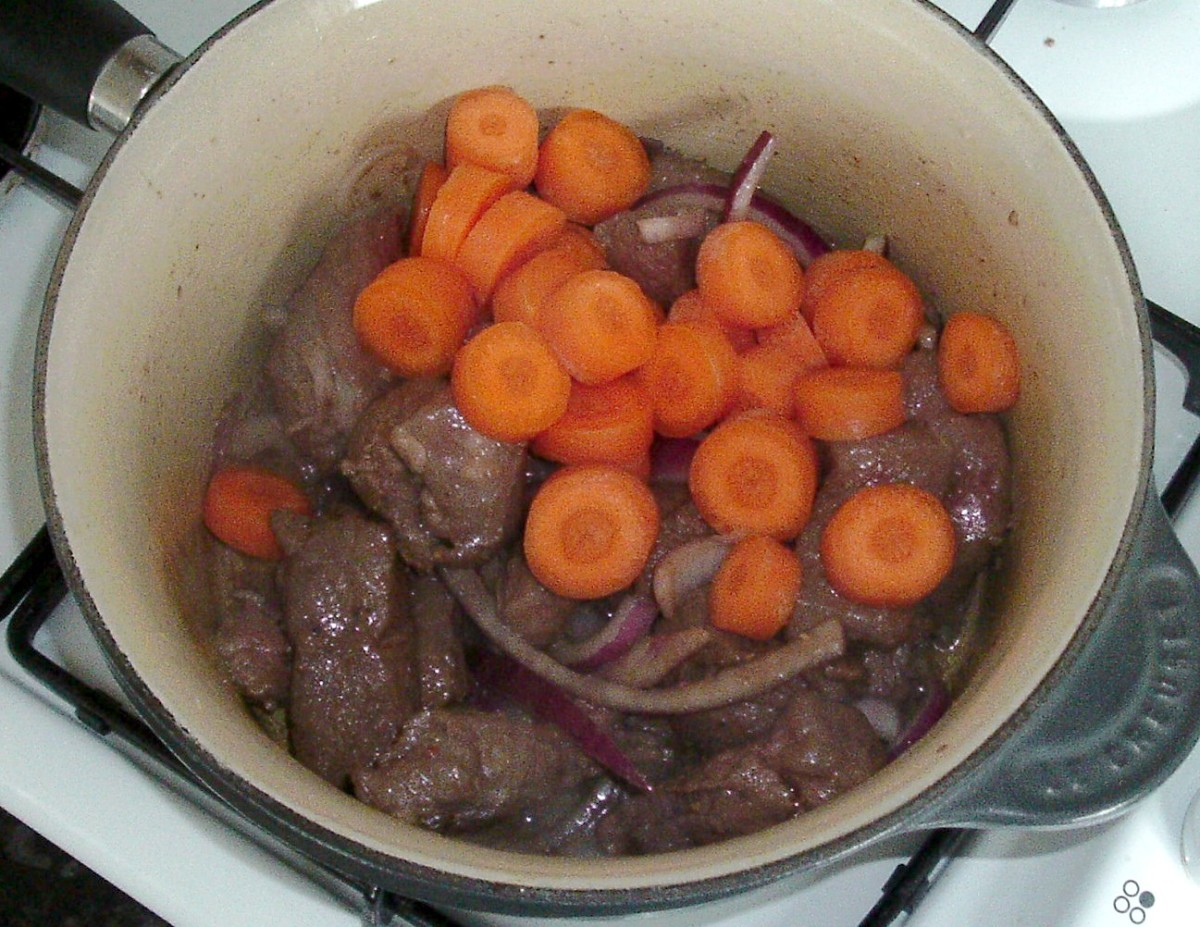 Sliced carrots are added to the alpaca and onion
