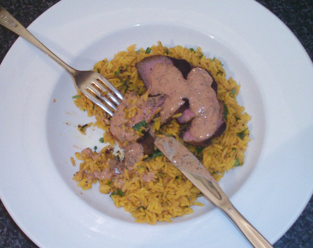 Enjoying curried ostrich fillet steak and spicy sauce on turmeric rice.