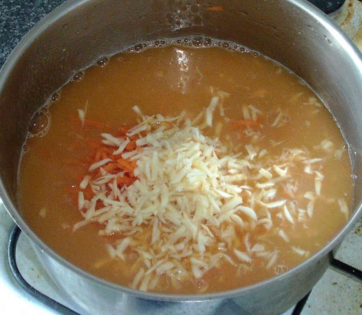 Carrot and parsnip is grated in to blended soup