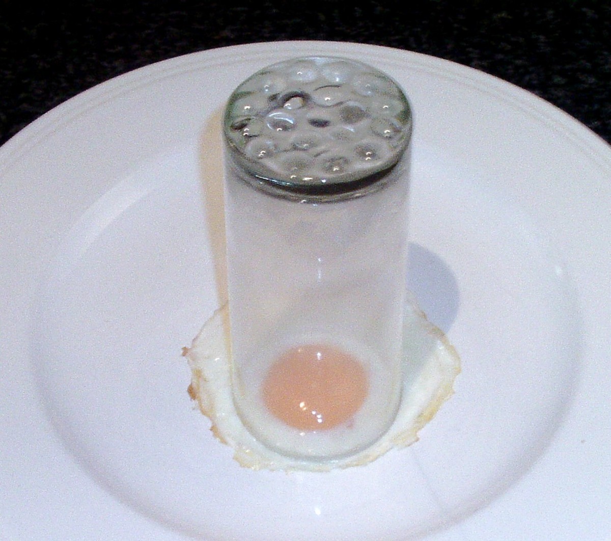 Small diameter drinking glass is used to cut circle from fried egg