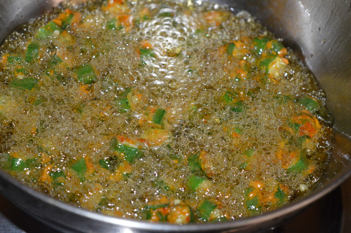 Deep-frying the okra pakora mix.