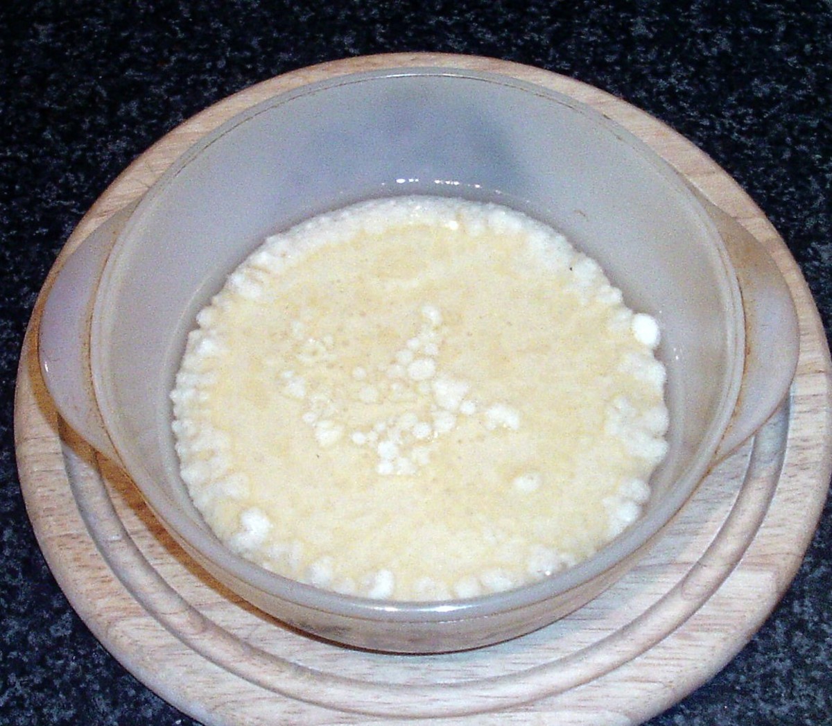 Pour Yorkshire pudding batter into hot oil