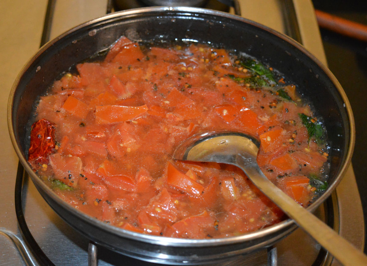Step four: Add cooked tomatoes. Bring the mixture to a boil. 