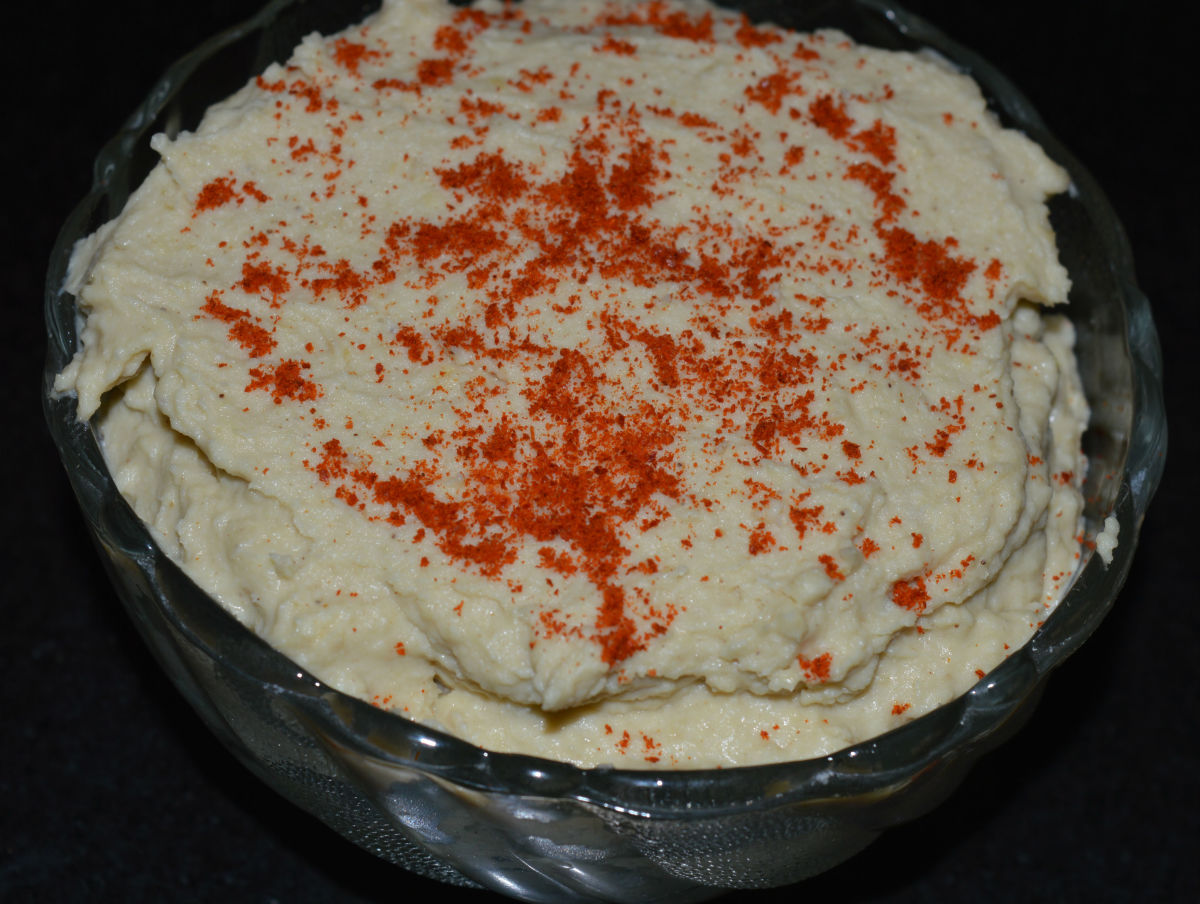 Step five: Add a layer of paprika on the top. Mix it at the time of using. This way, your yummy hummus is ready to serve! Eat it as a dip or spread. Enjoy eating this protein-rich hummus.