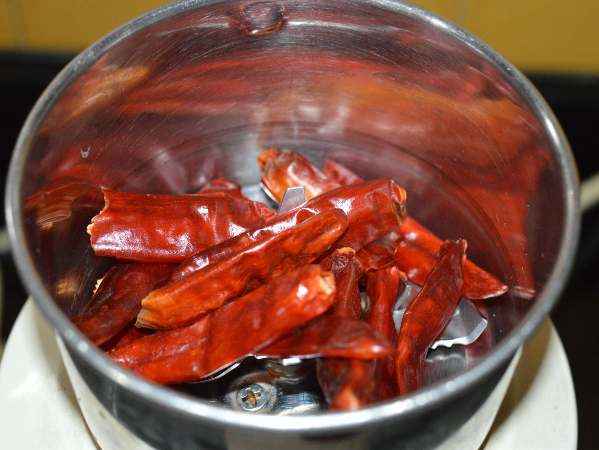 Step one: Spread flat skin dry red chilies under the sun for about two days or until the chilies are crispy. Alternatively, you can put them inside a warm oven for some time to make them crispy. Next, put them in a mixer.