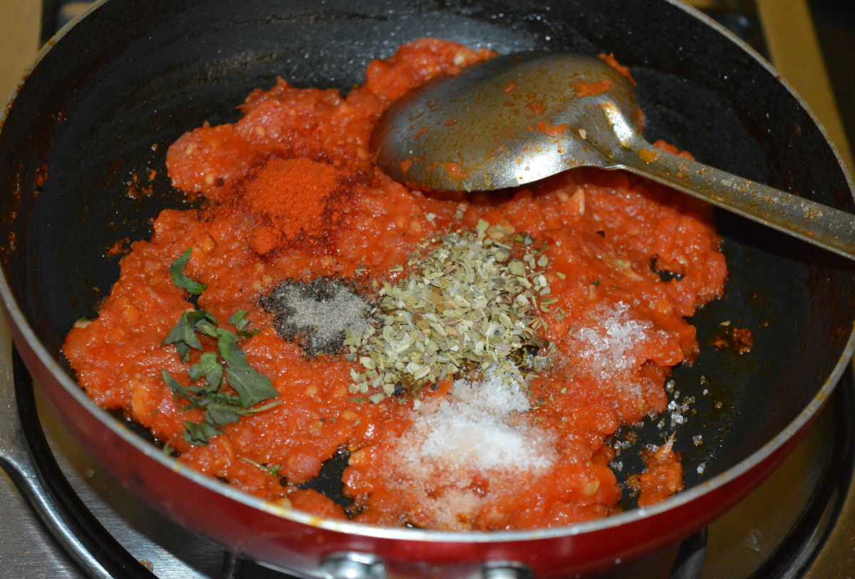 Step four: Add dried oregano, red chili powder, pepper powder, sugar, salt, and chopped fresh basil.