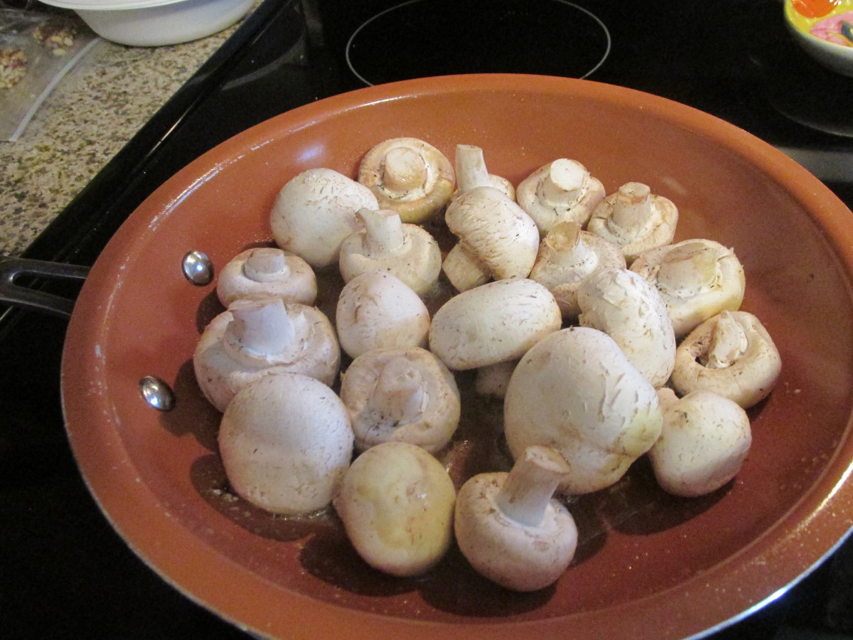 Raw, cleaned mushrooms in a hot pan.
