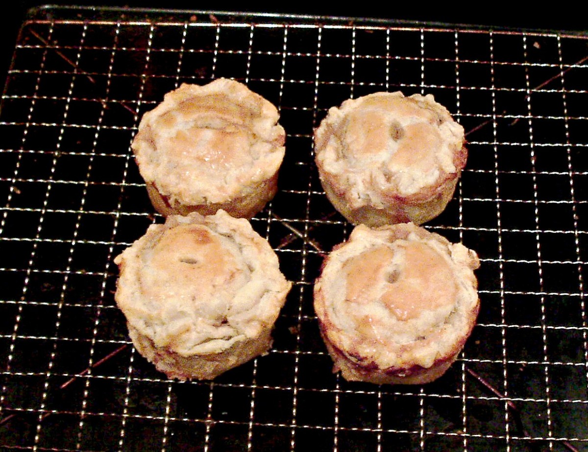 Venison and red wine gravy pies are rested on a wire rack