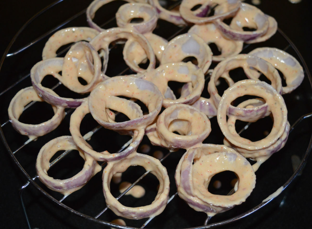 Step five: Dip each of the onion rings in the batter. Place them on a wire rack.