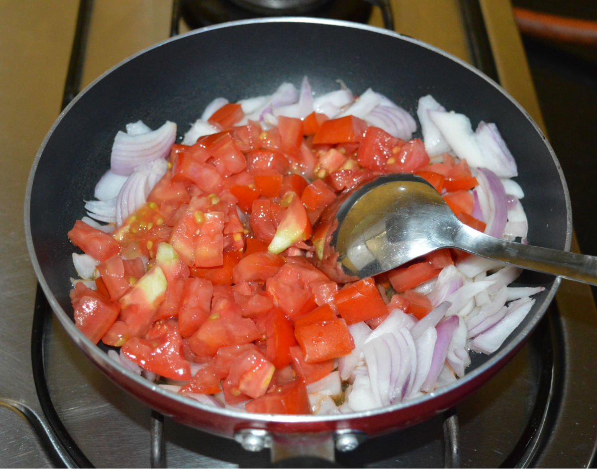 Step one: Saute chopped onions and tomatoes in oil until they are soft. Add some salt to quicken the cooking process.