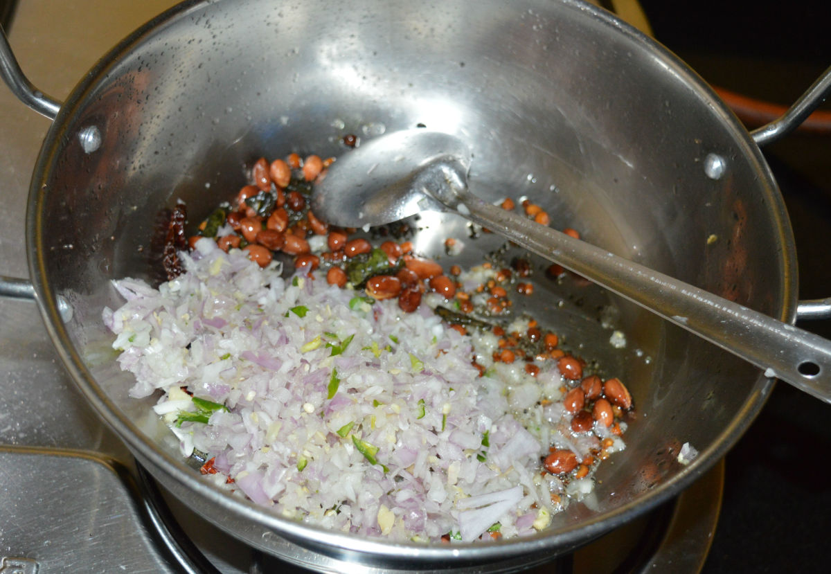 Step four: Add chopped onions, ginger, and green chilies. Saute until onions are transparent.