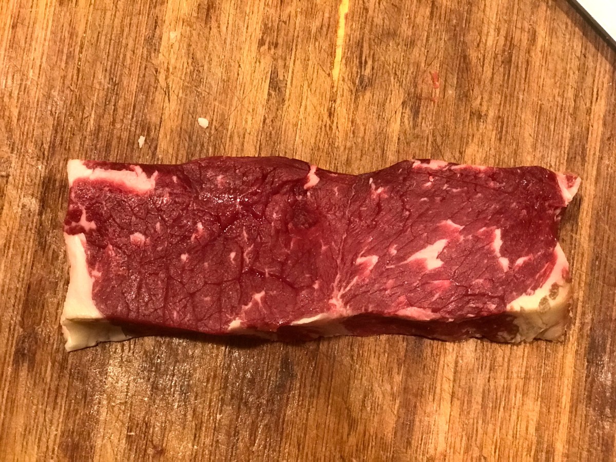Dry-aged trimmed NY steak. After 45 days of aging, there is still a small amount of blood in a trimmed steak.