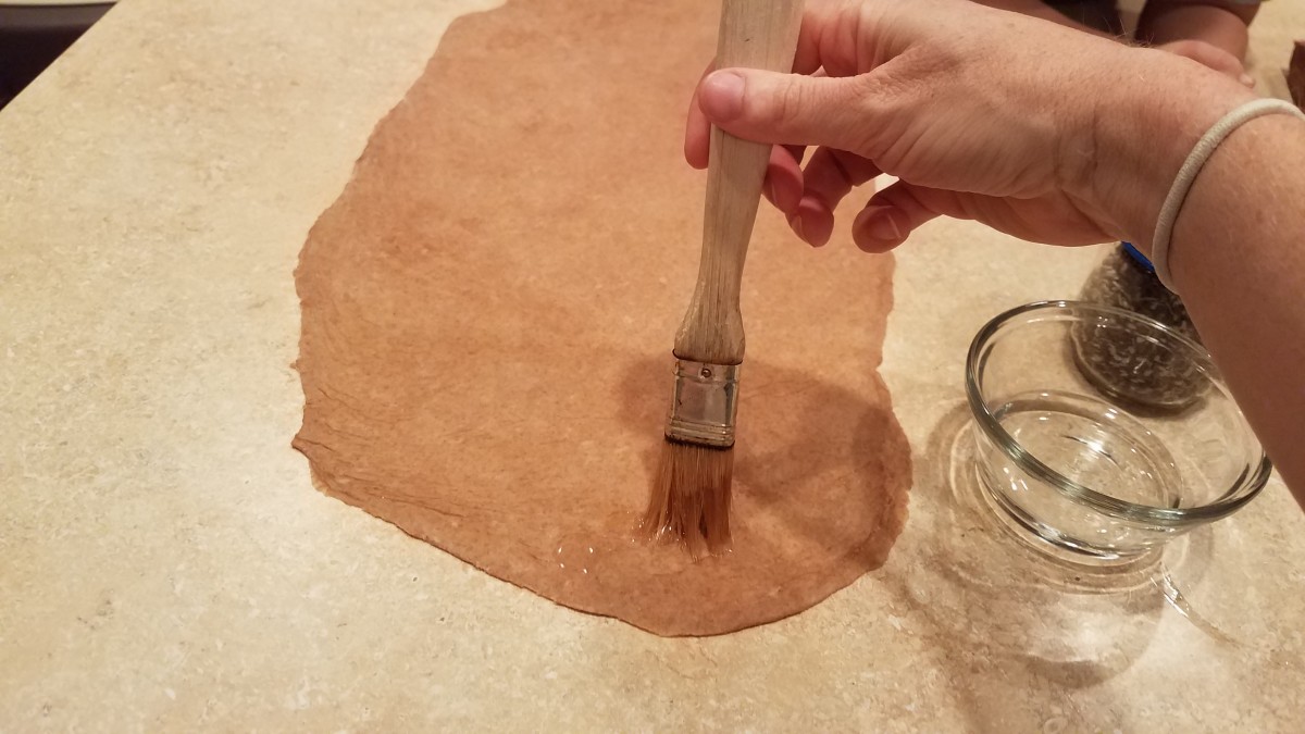 Brush your dough lightly with water.