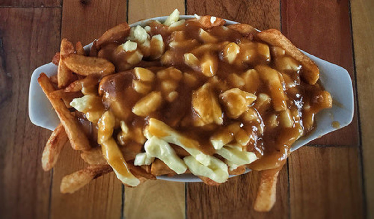 Poutine from Quebec is fries covered in cheese curds and thick brown gravy.